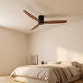 Bozeman ceiling fan in walnut and matte black above a bed