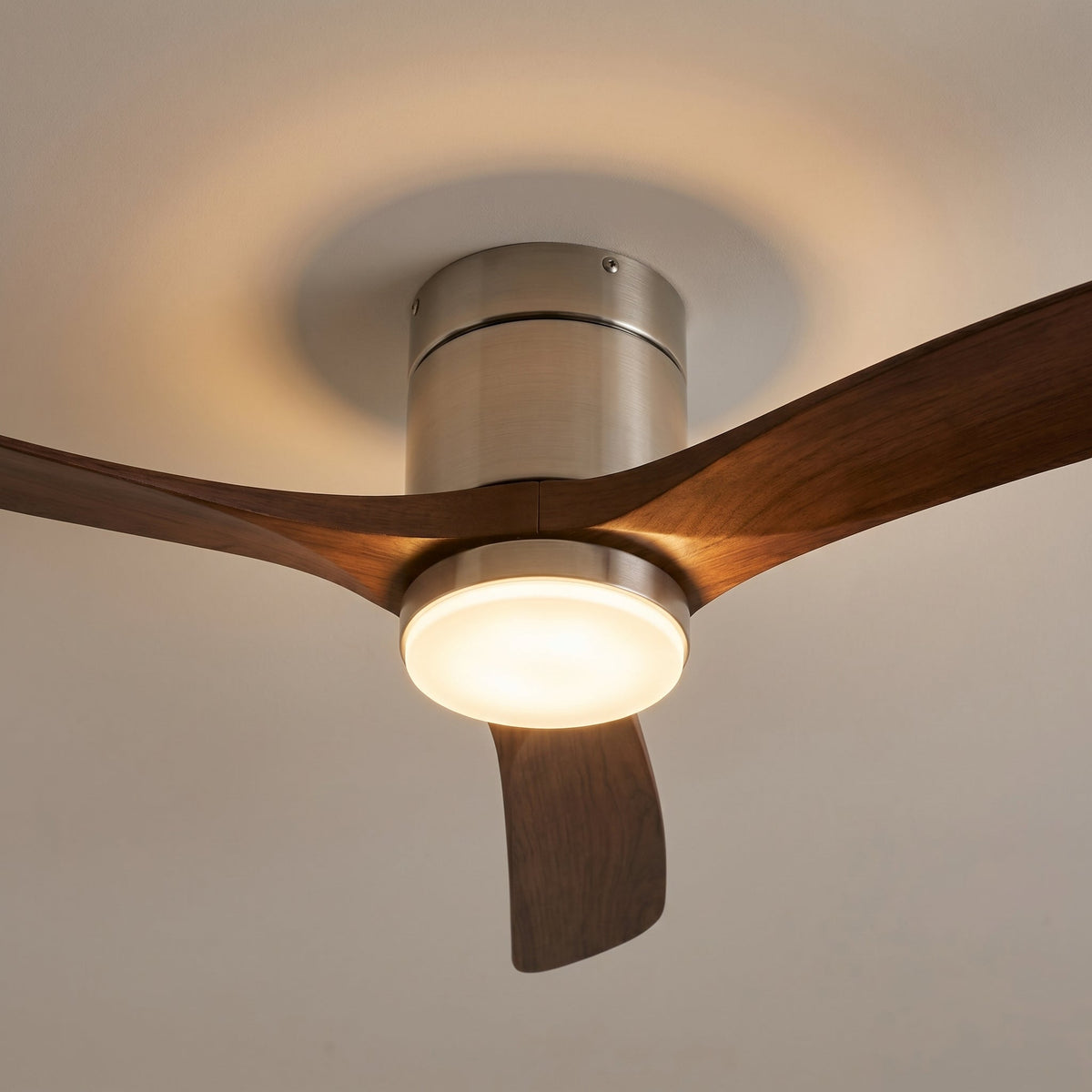 Close-up of the brushed silver housing where the dark walnut blades meet